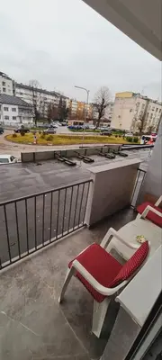 a red and white chair sitting on top of a balcony at LARA S in Banja Luka