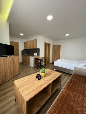 a hotel room with a bed and a coffee table at Aparmani Karanovic in Zavidovići