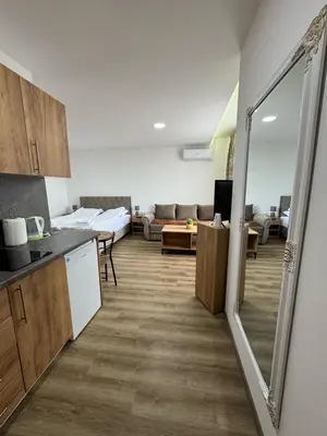a room with a kitchen and a living room at Aparmani Karanovic in Zavidovići