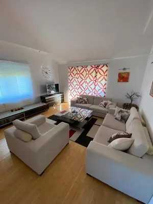 a living room with two couches and a tv at Apartman GOGO in Livno