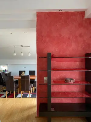 a red wall in a room with a dining room at Apartman GOGO in Livno