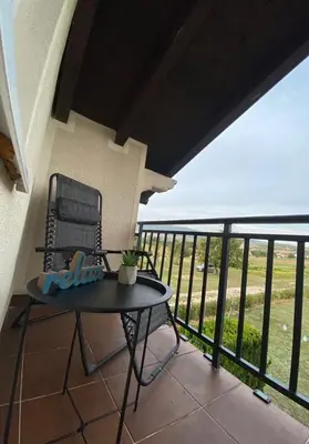 a patio with a table and a chair on a balcony at Apartman GOGO in Livno