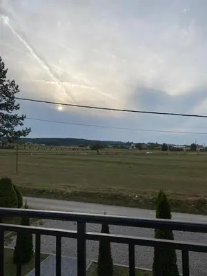 a view of a field with a fence and a road at Apartman GOGO in Livno