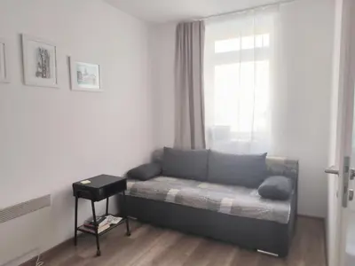 a living room with a couch and a window at Kupres, centar, apartman in Kupres
