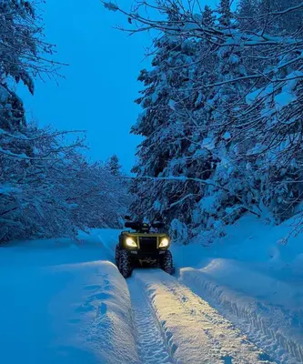 a jeep driving down a snow covered road at Kupres, centar, apartman in Kupres