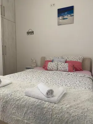 a bedroom with a bed with a dog laying on it at Alexandra apartment in Banja Luka