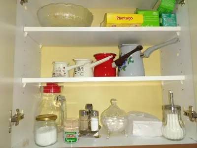 a kitchen pantry with jars and other items on shelves at Stan na dan Apartman Kozarac in Kozarac