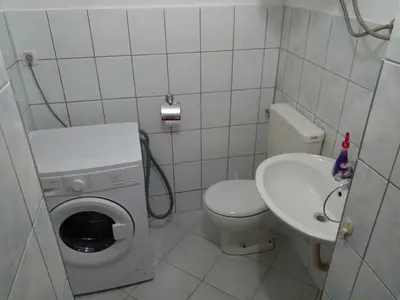 a small bathroom with a toilet and a sink at Stan na dan Apartman Kozarac in Kozarac