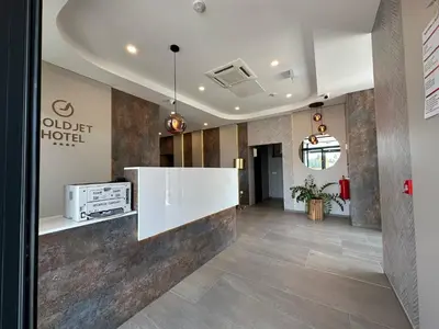 a lobby of an old detroit hotel with a white counter at Hotel GOLD JET Bihać in Bihać