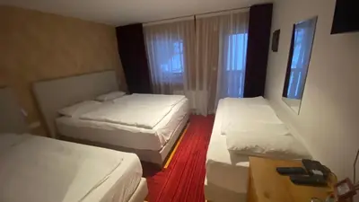 a room with three beds in a hotel room at Pansion Vlašić Ski in Šišava