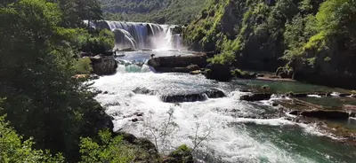 a waterfall in the middle of a river at Holiday home Dani in Bihać
