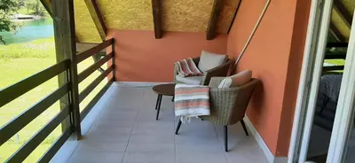 a porch with two chairs and a table on a balcony at Holiday home Dani in Bihać