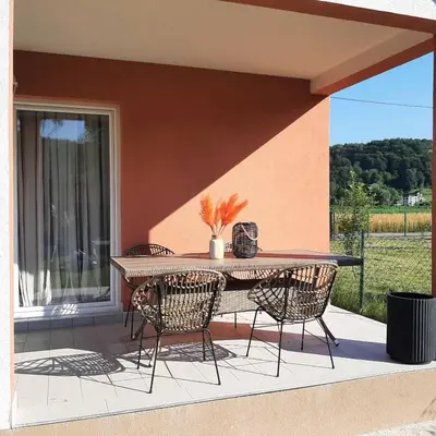 a patio with a table and chairs on a balcony at Holiday home Dani in Bihać
