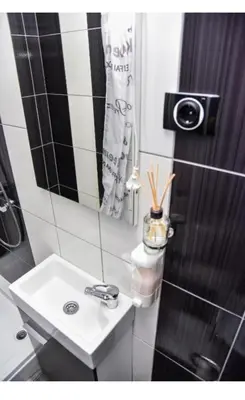 a white bathroom with a sink and a mirror at Amsterdam in Banja Luka