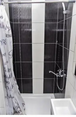 a bathroom with a shower curtain and a sink at Amsterdam in Banja Luka
