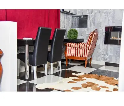a dining room with a table and a chair and a table at Amsterdam in Banja Luka