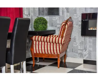 a wooden chair sitting in front of a table at Amsterdam in Banja Luka