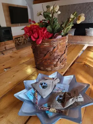 a table with a star plate and a basket of flowers at Cozy Cottage Vlašić in Vlasic