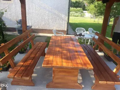a wooden table and benches on a patio at Apartmani Villas in Visoko