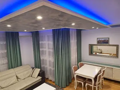 a living room with a couch and a table at Elegantna oaza apartment in Banja Luka
