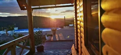 a view from a window of a house with the sunset at Koliba La Perla in Banja Luka