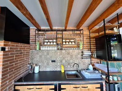 a kitchen with a sink and a brick wall at Koliba La Perla in Banja Luka