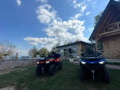 two motorcycles parked in a yard next to a house at Koliba La Perla in Banja Luka
