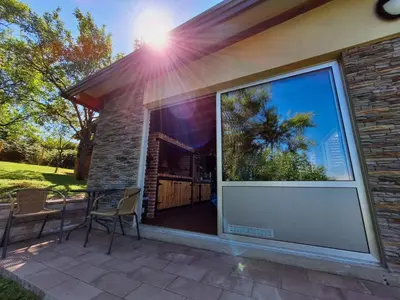 a large window of a house with a table and chairs at Koliba La Perla in Banja Luka