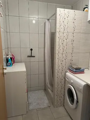 a bathroom with a washing machine and a shower at Apartment Sunny day in Livno