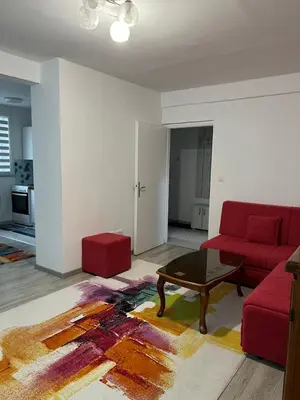 a living room with a red couch and a coffee table at Apartman “ Ismar “ in Travnik