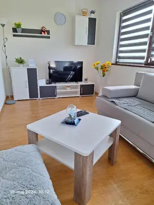 a living room with a white table and a couch at Stan na dan Grahovo in Bosansko Grahovo