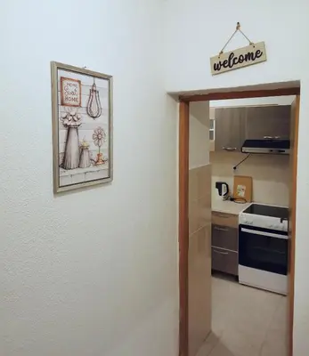 a door to a kitchen with a picture on the wall at Stan na dan Grahovo in Bosansko Grahovo