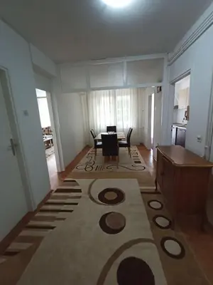 a living room with a table and a dining room at Apartmani Vesna in Banja Luka