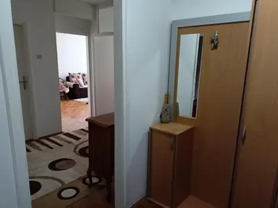 a hallway with a door and a mirror and a room at Apartmani Vesna in Banja Luka