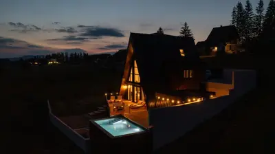a house lit up at night with lights on it at Euphoria - luxury villa in Vlasic