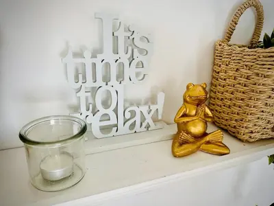a candle and a teddy bear sitting on a shelf with a basket at Vila Milincic Milincic Nest in Banja Luka