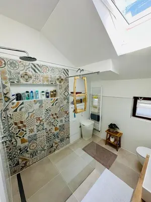 a bathroom with a shower with a toilet and a window at Vila Milincic Milincic Nest in Banja Luka