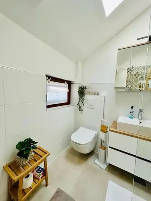 a white bathroom with a toilet and a sink at Vila Milincic Milincic Nest in Banja Luka