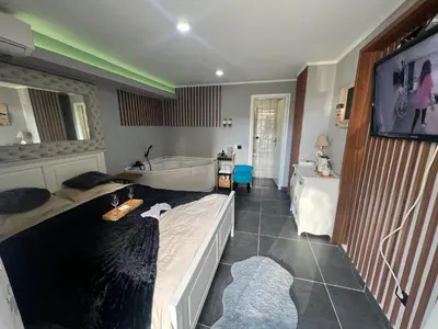 a bedroom with a bed and a tub and a sink at Apartman Banja Luka CITY in Banja Luka