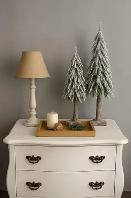 two christmas trees on top of a dresser with a lamp at Apartman Banja Luka CITY in Banja Luka
