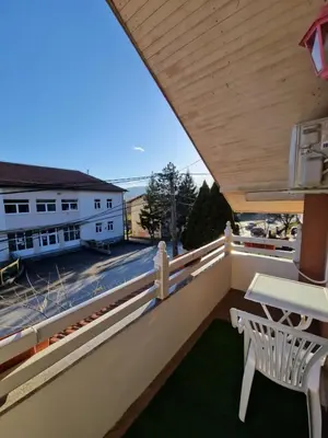 a balcony with a table and a white chair at Stara Ruža in Gračanica
