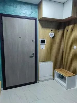 a room with a large door and a bench in it at APARTMAN ANIKA - STAN NA DAN Doboj in Doboj