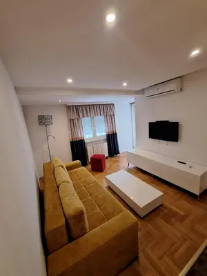 a living room with a couch and a flat screen tv at Luks 2 apartment in Banja Luka