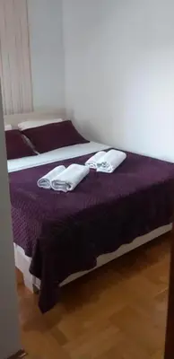 a bedroom with two beds with white towels on them at Luks 2 apartment in Banja Luka