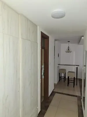 a hallway with a dining room and a table at Luks 2 apartment in Banja Luka