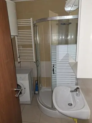 a bathroom with a sink and a shower and a toilet at Luks 2 apartment in Banja Luka