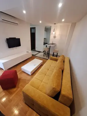 a living room with a couch and a tv at Luks 2 apartment in Banja Luka