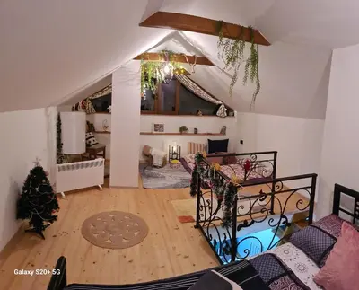 a living room with an attic with a ceiling at Vikendica 