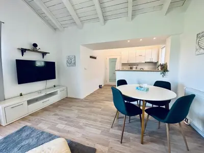 a kitchen and a dining room with a table and chairs at Vila Milincic Loft Milincic in Banja Luka