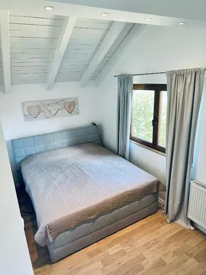 a bedroom with a bed and a large window at Vila Milincic Loft Milincic in Banja Luka